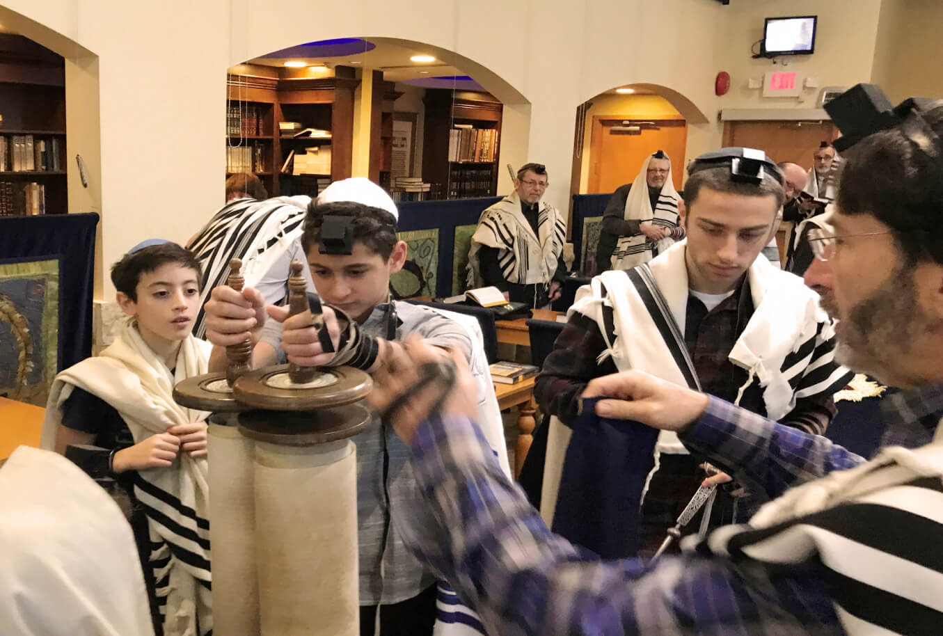 Kids holding sefer Torah